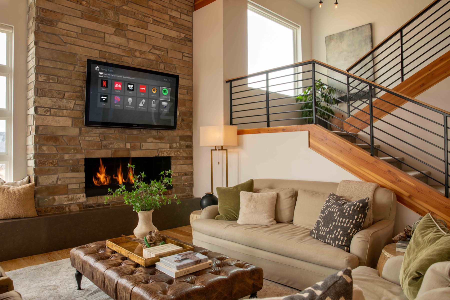 Living room with an integrated control touchscreen and fireplace